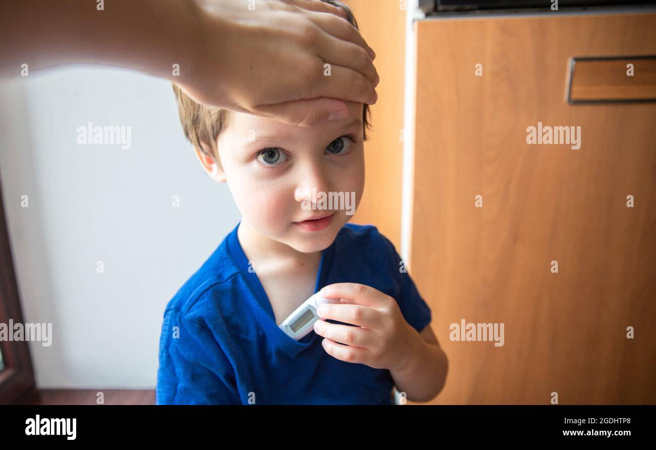 Child with fever in home getting temperature taken Stock Photo Alamy