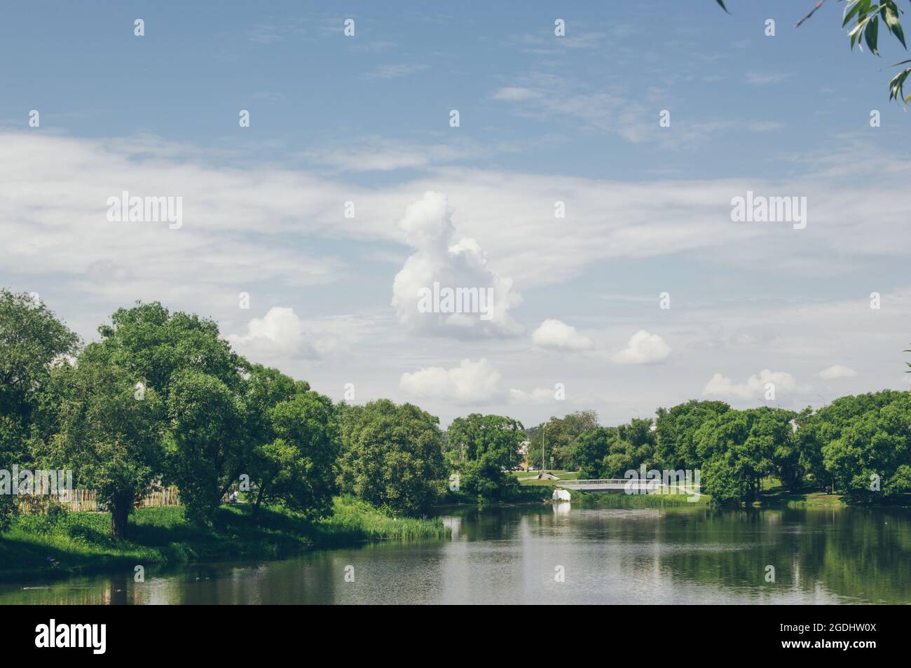 River summer green landscape with a bridge and a cloudy sky in clear ...