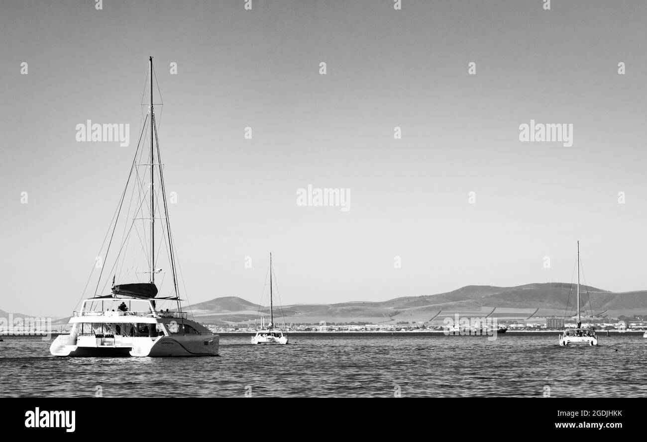CAPE TOWN, SOUTH AFRICA - Jan 06, 2021: A view of tourists riding on a catamaran yacht in the sea in Cape Town, South Africa Stock Photo