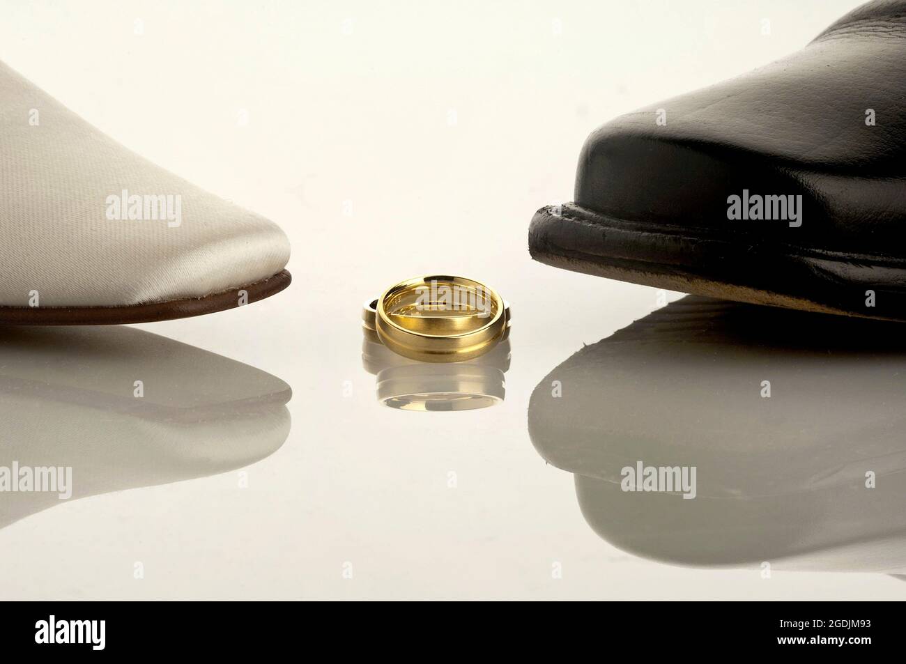 wedding shoes and golden wedding rings Stock Photo