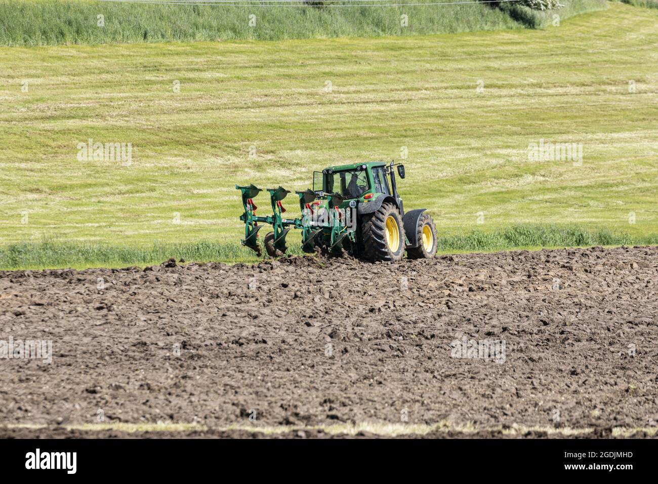 ploughing of grassland at the bank protection of a small brook, Germany, Bavaria Stock Photo