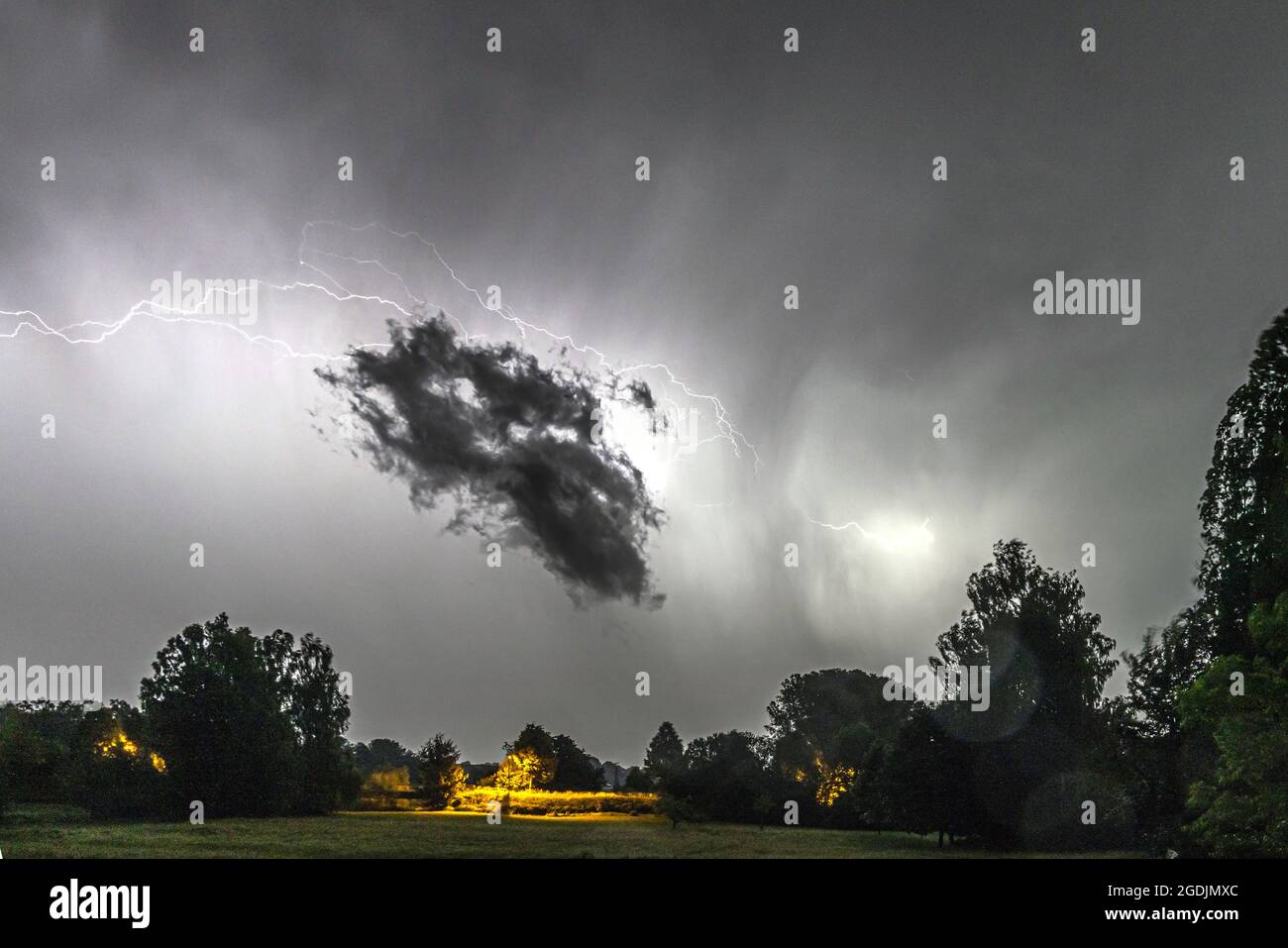 black cloud in front of flashing lightning, Germany, Bavaria, Isental Stock Photo