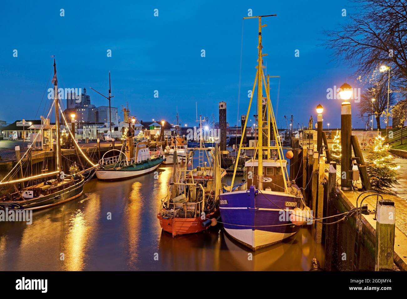 historic harbour at Christmas time in the evening, Germany, Schleswig-Holstein, Buesum Stock Photo
