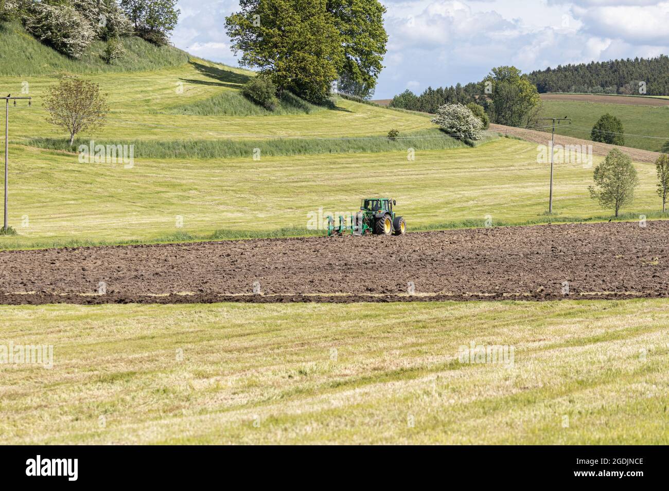 ploughing of grassland at the bank protection of a small brook, Germany, Bavaria Stock Photo