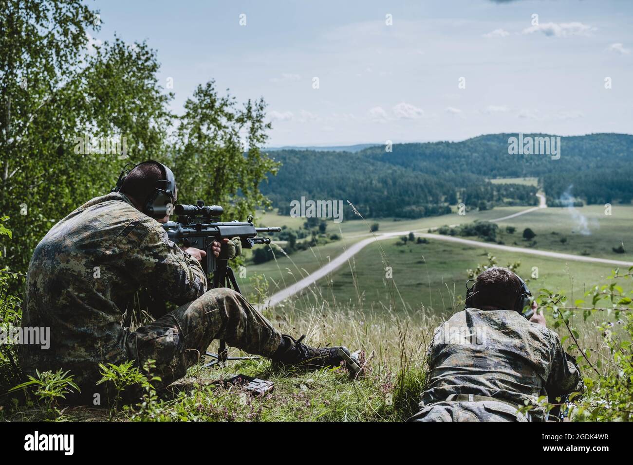 A Bulgarian sniper team spots and shoots targets after calling for artillery fire on a simulated missile launcher during the 2021 Best Sniper Team Competition at Hohenfels Training Area, Germany, Aug. 12, 2021. The 2021 European Sniper Team Competition is a U.S. Army Europe and Africa-directed, 7th Army Training Command hosted contest of skill that includes 14 participating NATO allies and partner nations at 7th ATC's Hohenfels Training Area, August 8-14. The European Best Sniper Team Competition is designed to improve professionalism and enhance esprit de corps. (U.S. Army National Guard phot Stock Photo