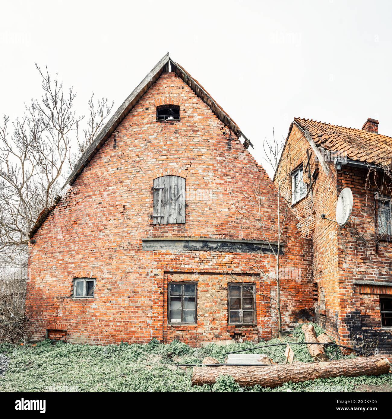 Facade of old German brick house with burnt wall in poor condition Stock Photo
