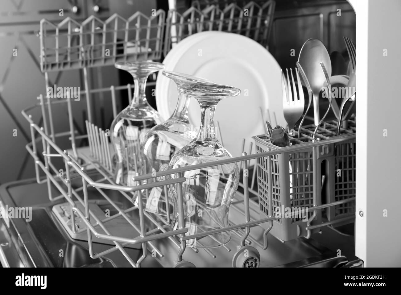 Open dishwasher with clean utensils in it Stock Photo Alamy