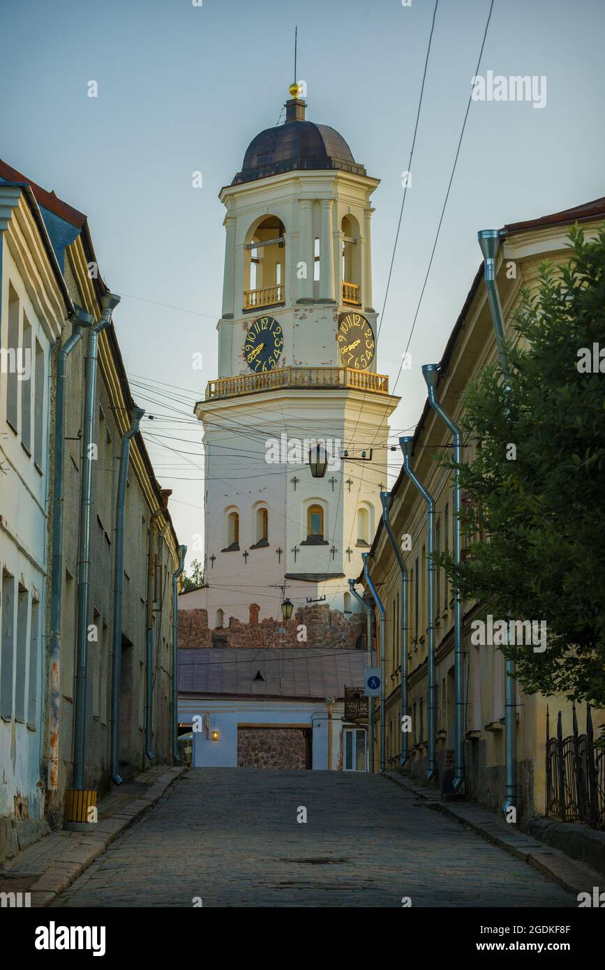 View of the old Clock Tower from Vodnaya Zastava Street on an August evening. Vyborg, Russia Stock Photo
