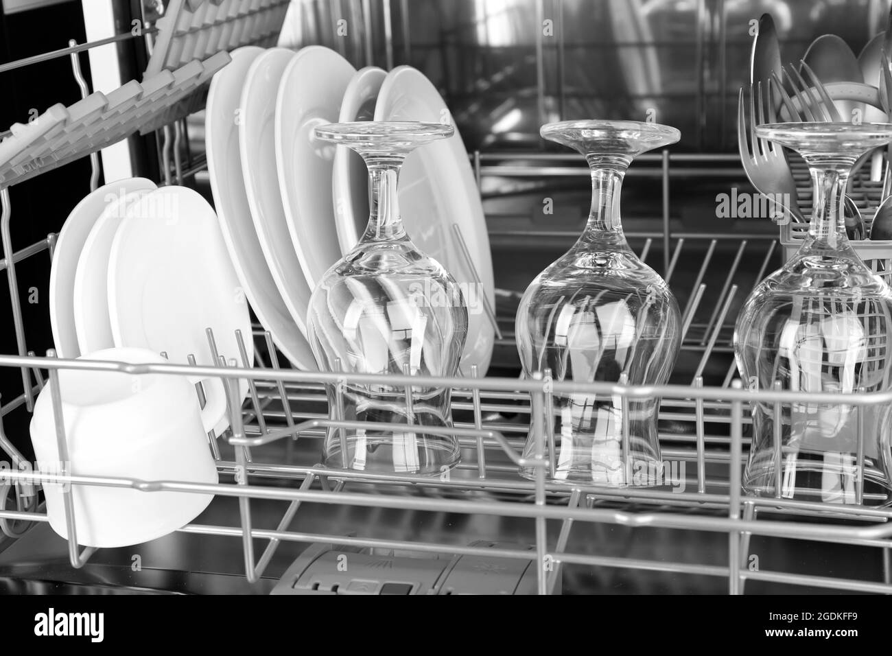 Open dishwasher with clean utensils in it Stock Photo Alamy