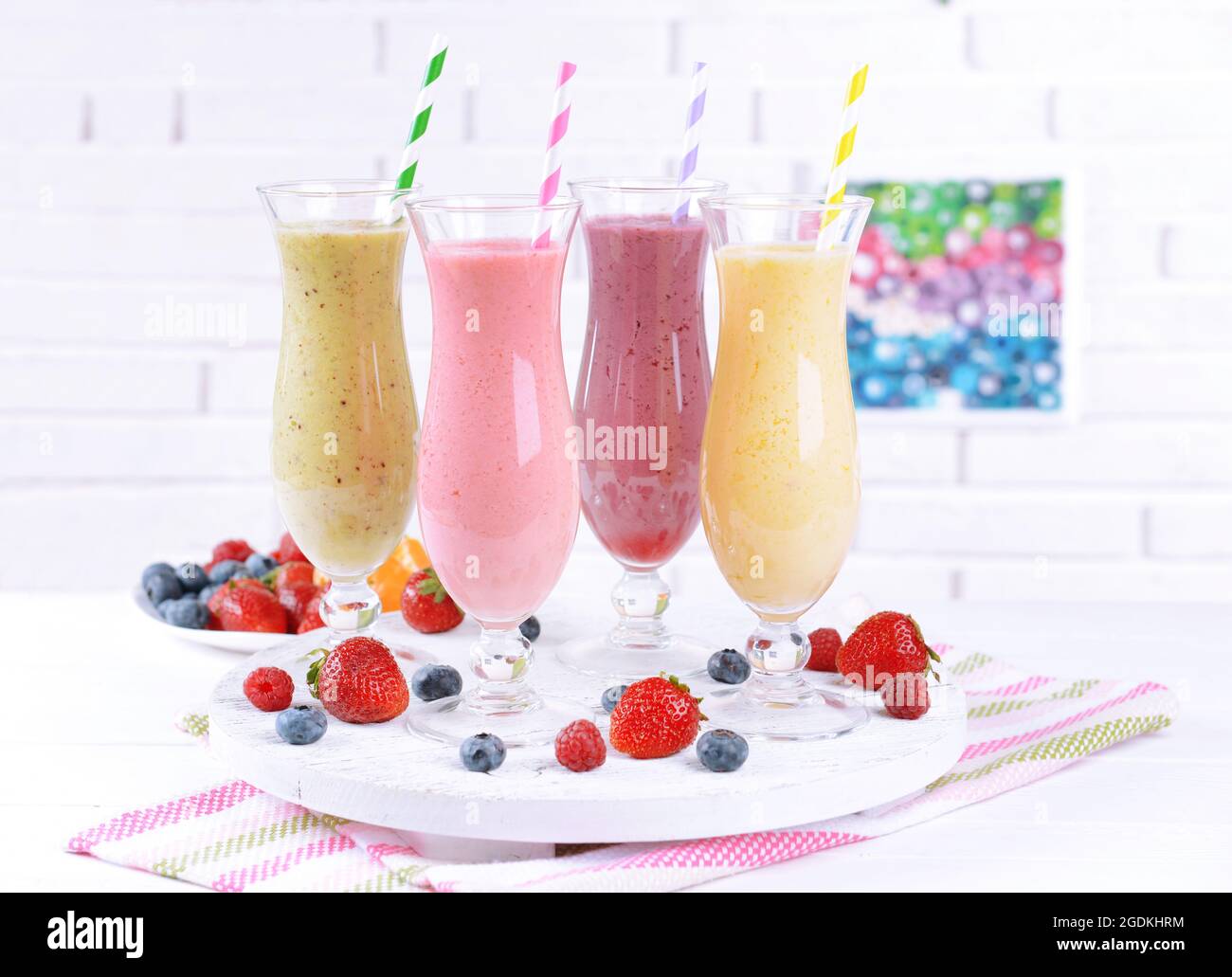 Delicious berry cocktails on table on brick wall background Stock Photo