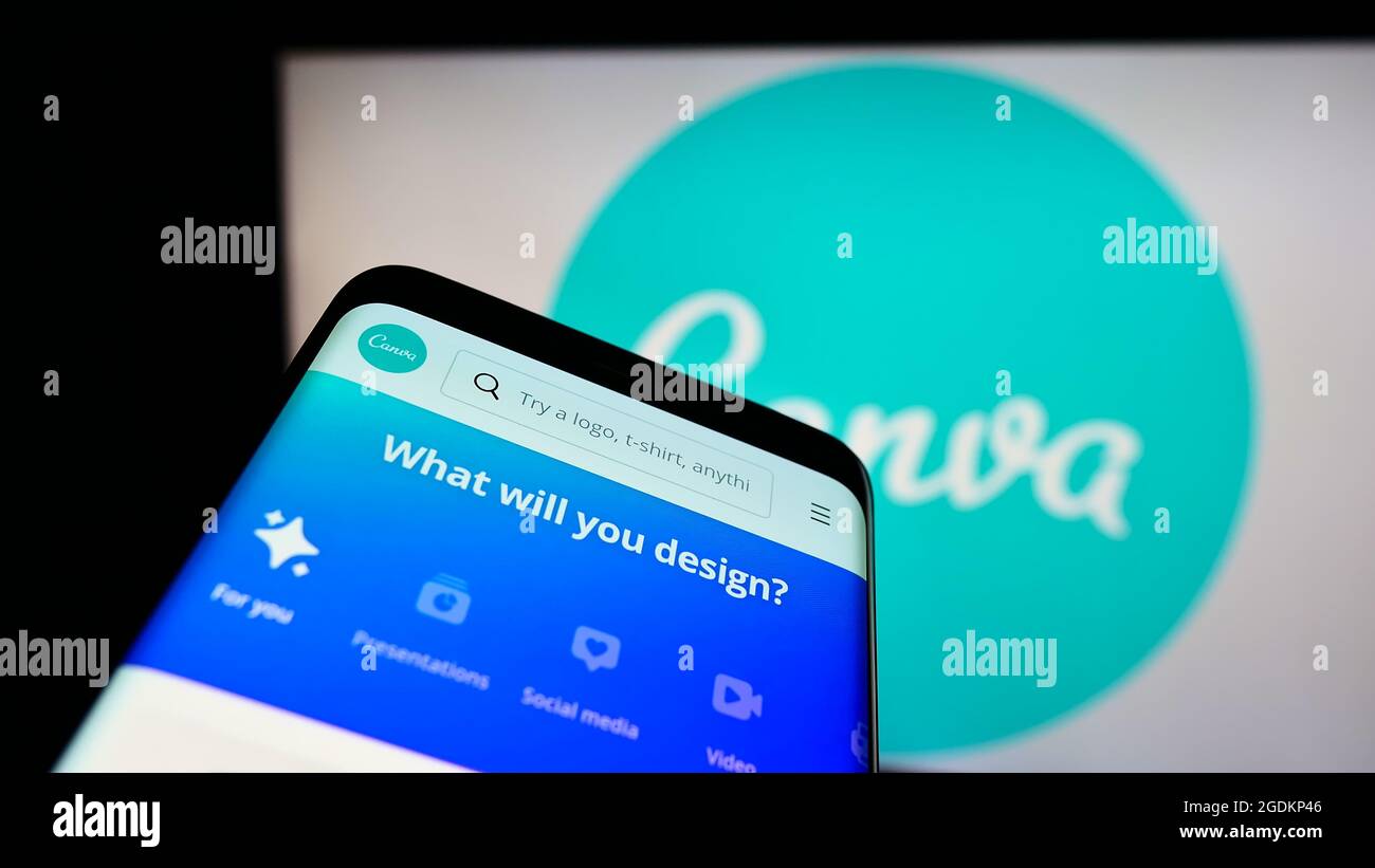 Mobile phone with website of Australian graphic design company Canva Pty Ltd on screen in front of logo. Focus on top-left of phone display. Stock Photo