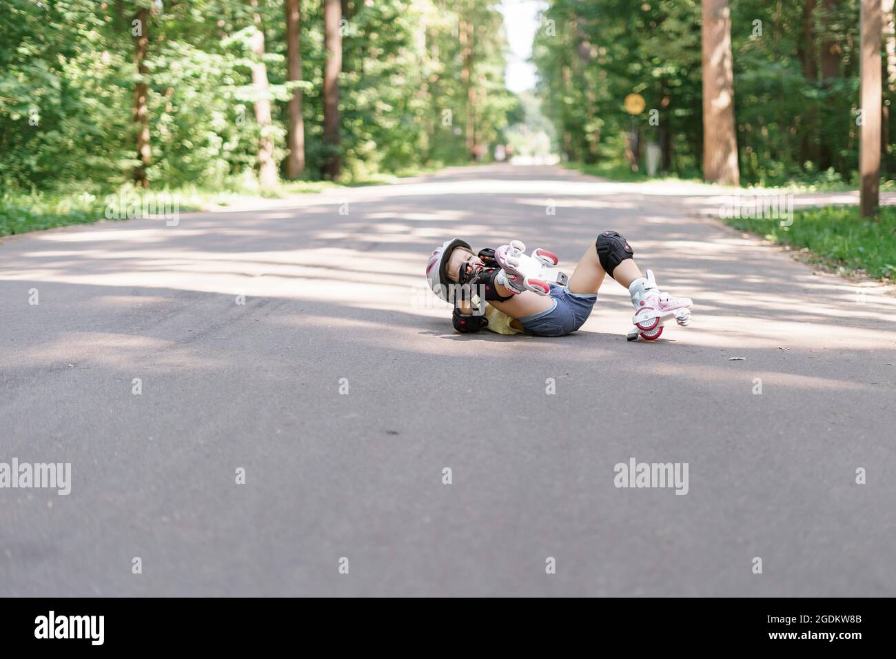 baby in protective sportswear. little girl got a knee injury while