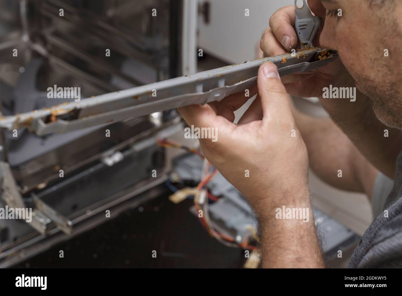 the man removed the grease and dirt rubber seal from the dishwasher