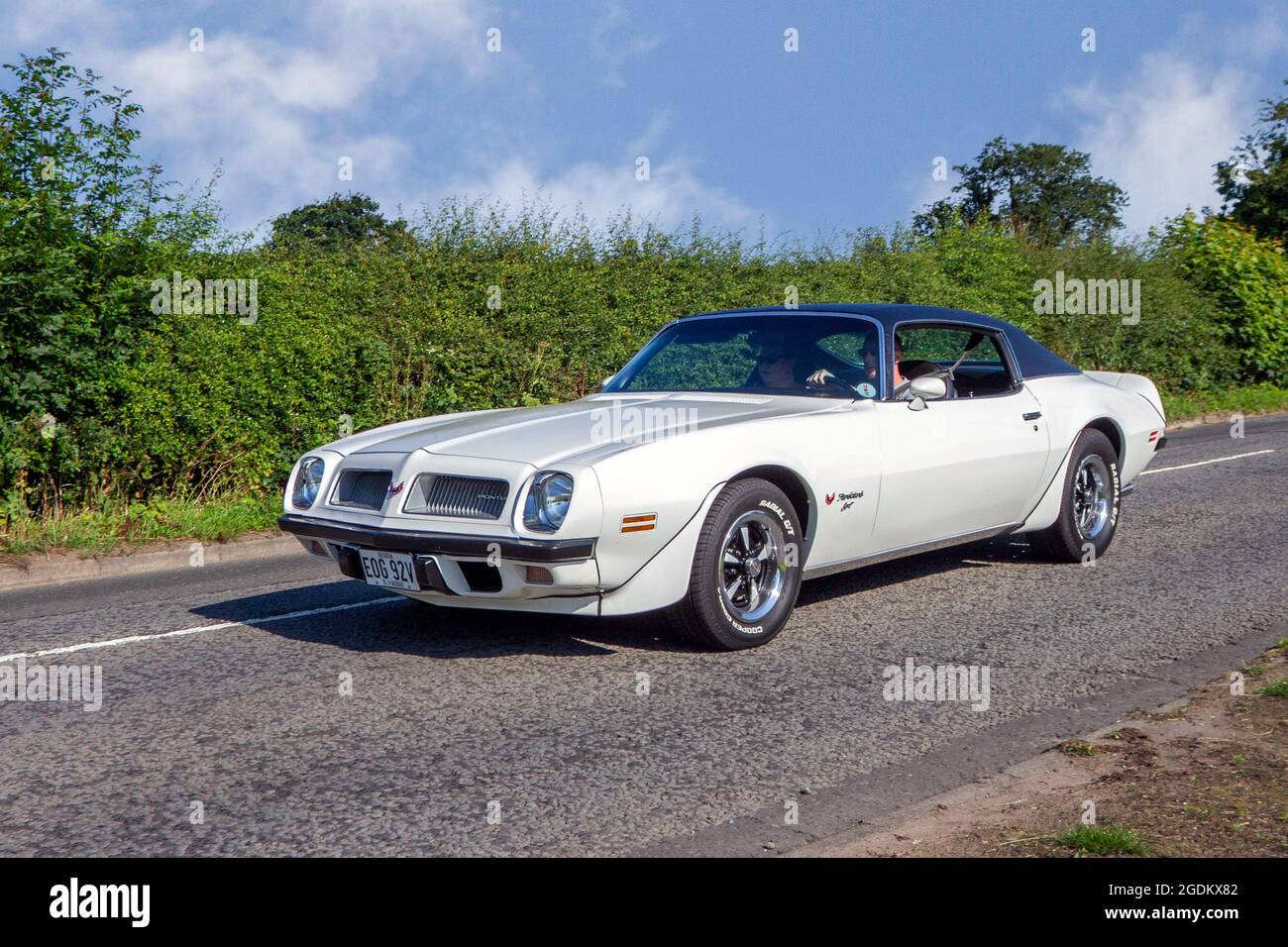 1974 70s white American Pontiac Firebird left hand drive  pony car 2dr coupe en-route to Capesthorne Hall classic July car show, Cheshire, UK Stock Photo