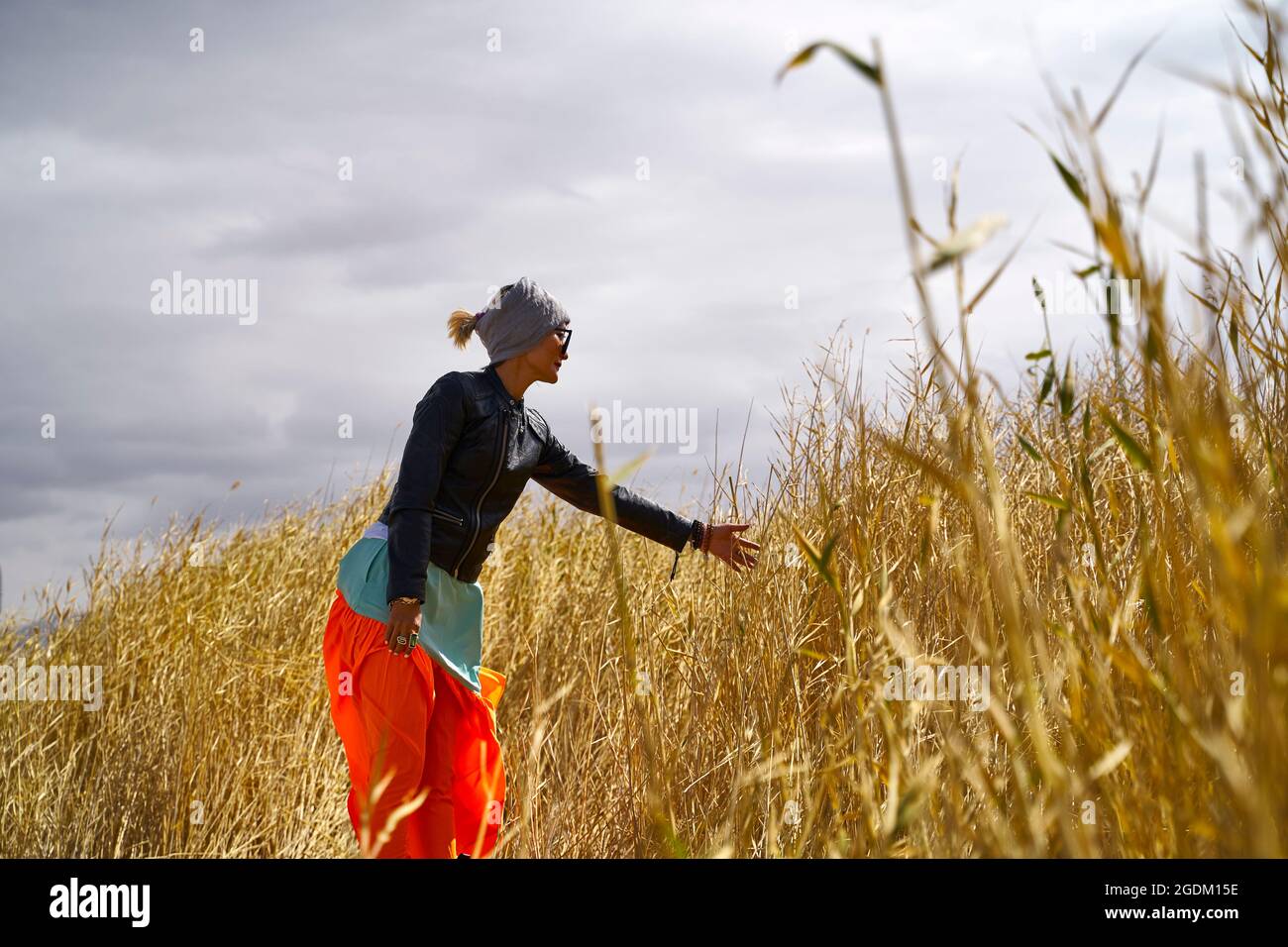 asian woman female tourist walking relaxing in a field of reeds marsh Stock Photo