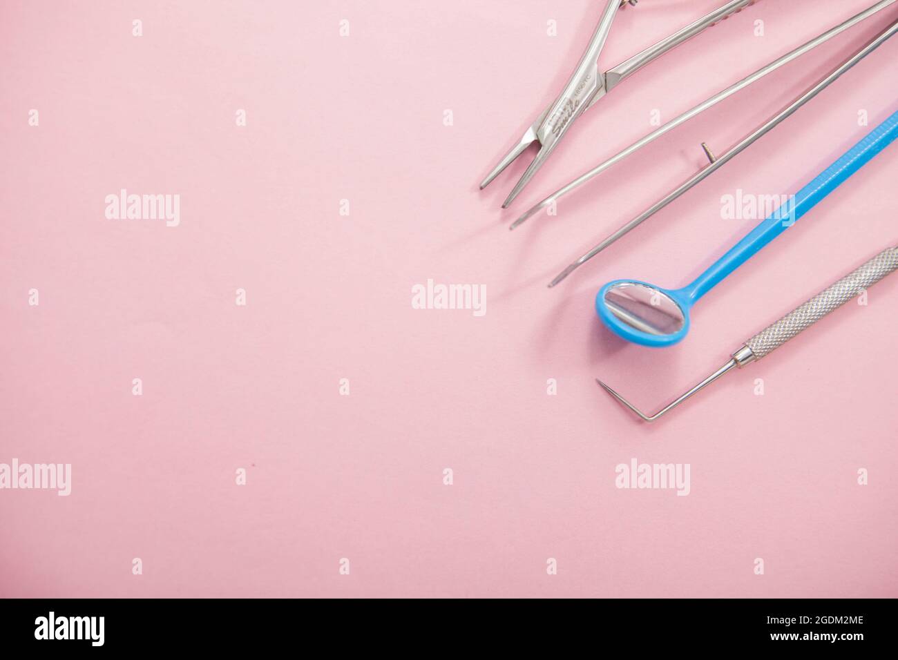 Top view close up of dentists tools on pink background, copy space Stock Photo