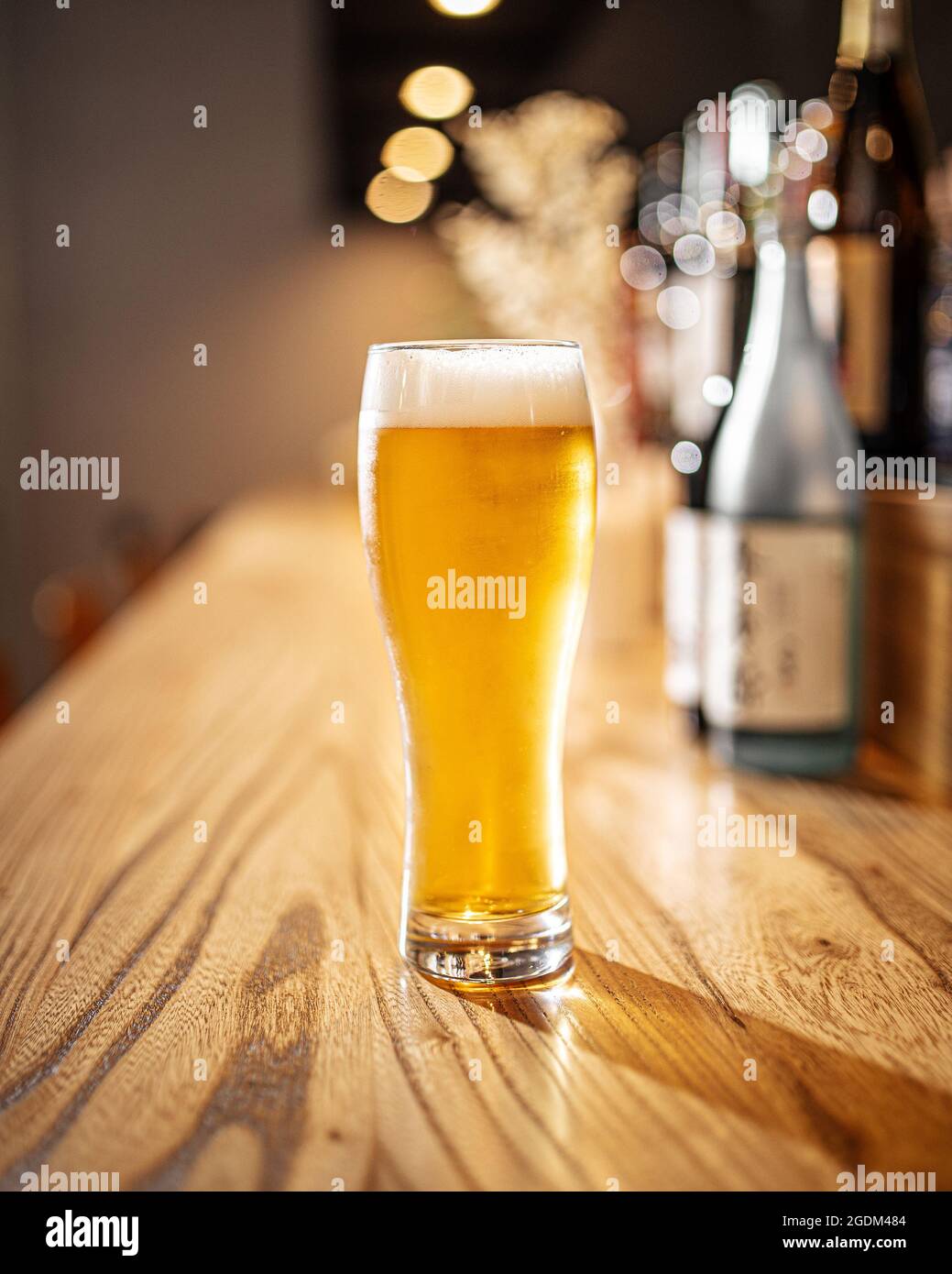 Glass of japanese light beer on a bar desk Stock Photo