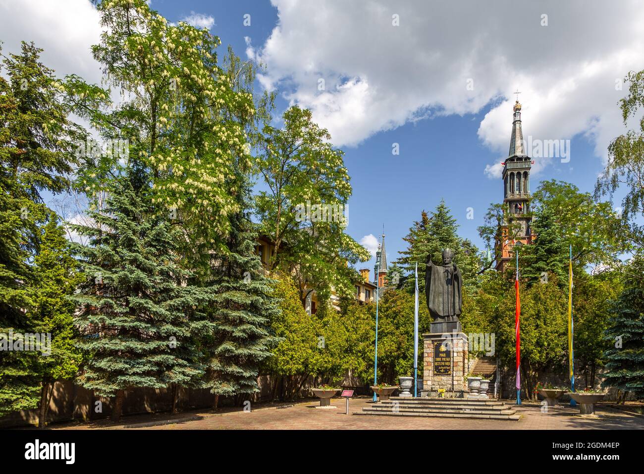 Lichen Stary, Poland - 25 May 2016: Monument to Pope John Paul II in front of the Saint Dorothy, neo-gothic parish church. Stock Photo
