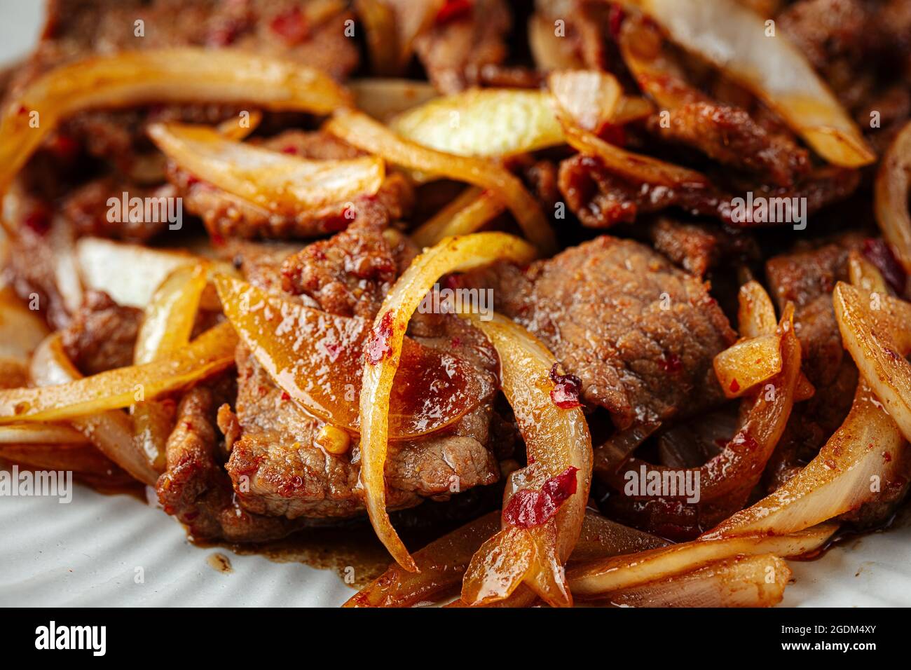 Asian spicy roast meat with onion Stock Photo