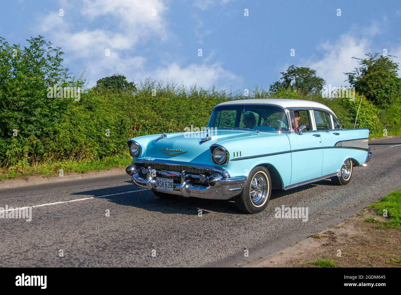 1957 50s blue white American Chevrolet GMC Chevy Bel-air 4dr saloon en-route to Capesthorne Hall classic July car show, Cheshire, UK Stock Photo