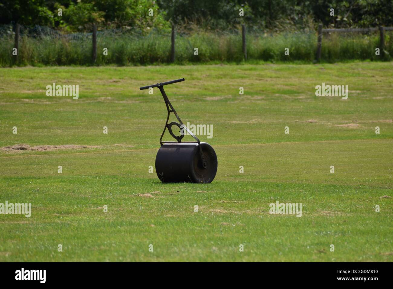 Manual roller in a countryside sports pitch Stock Photo