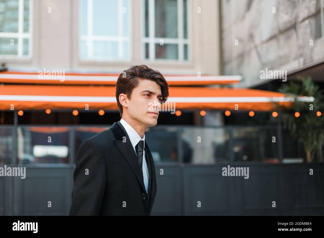 Shallow focus shot of a serious young Caucasian guy dressed ...
