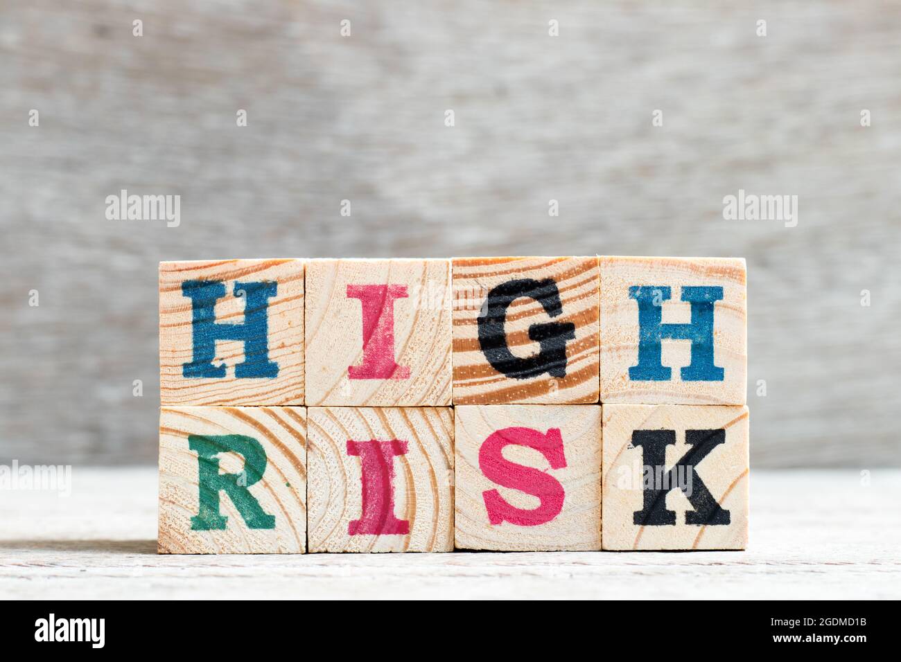 Letter block in word high risk on wood background Stock Photo - Alamy