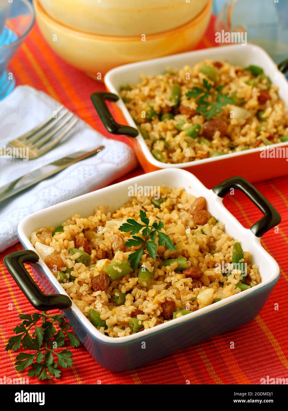 Rice, quinoa and bulgur with French greens and raisins. Stock Photo