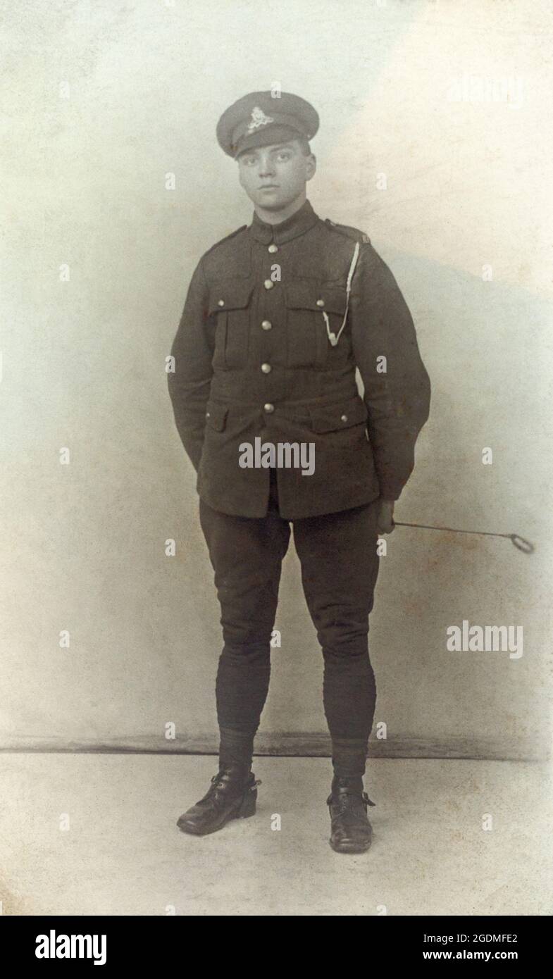 A portrait of a First World War British soldier, a Private in the Royal Artillery, standing, wearing spurs and holding a riding crop. The soldiers name is Henry. Stock Photo
