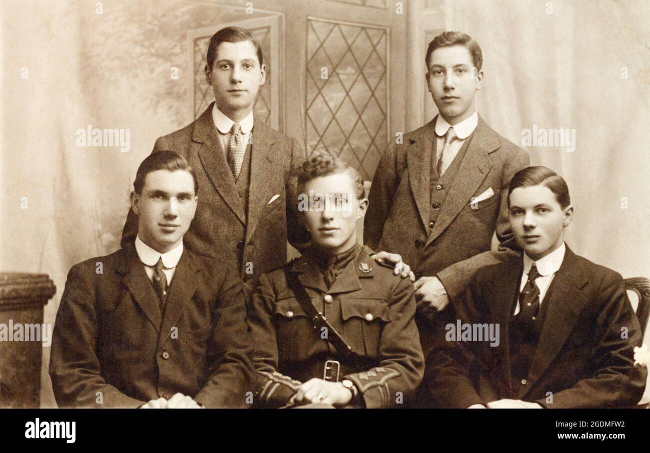 A portrait of a First World War British soldier, a Captain in the Essex Regiment, seated with 4 other men around him. Possibly family. Stock Photo
