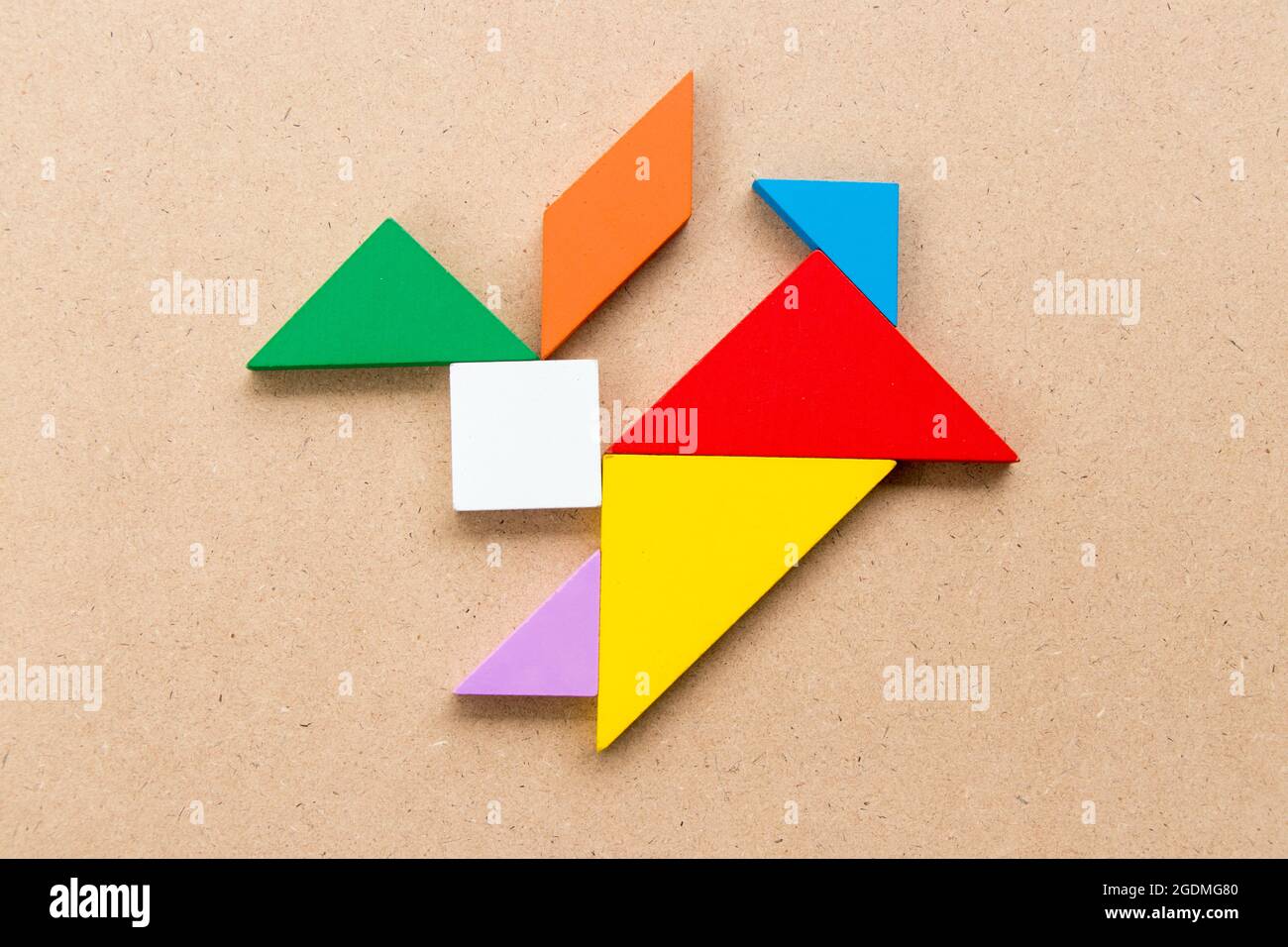 Color tangram puzzle in rabbit shape on wood background Stock Photo - Alamy