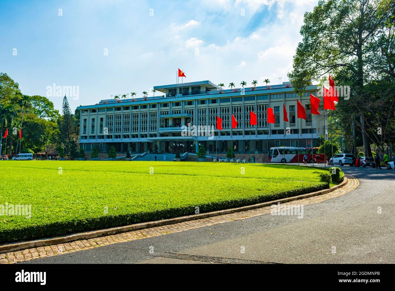 Ho Chi Minh City, Vietnam - CIRCA Jan 2020: The facade of Independence Palace, Ho Chi Minh City, Vietnam; with several Vietnamese national flags aroun Stock Photo