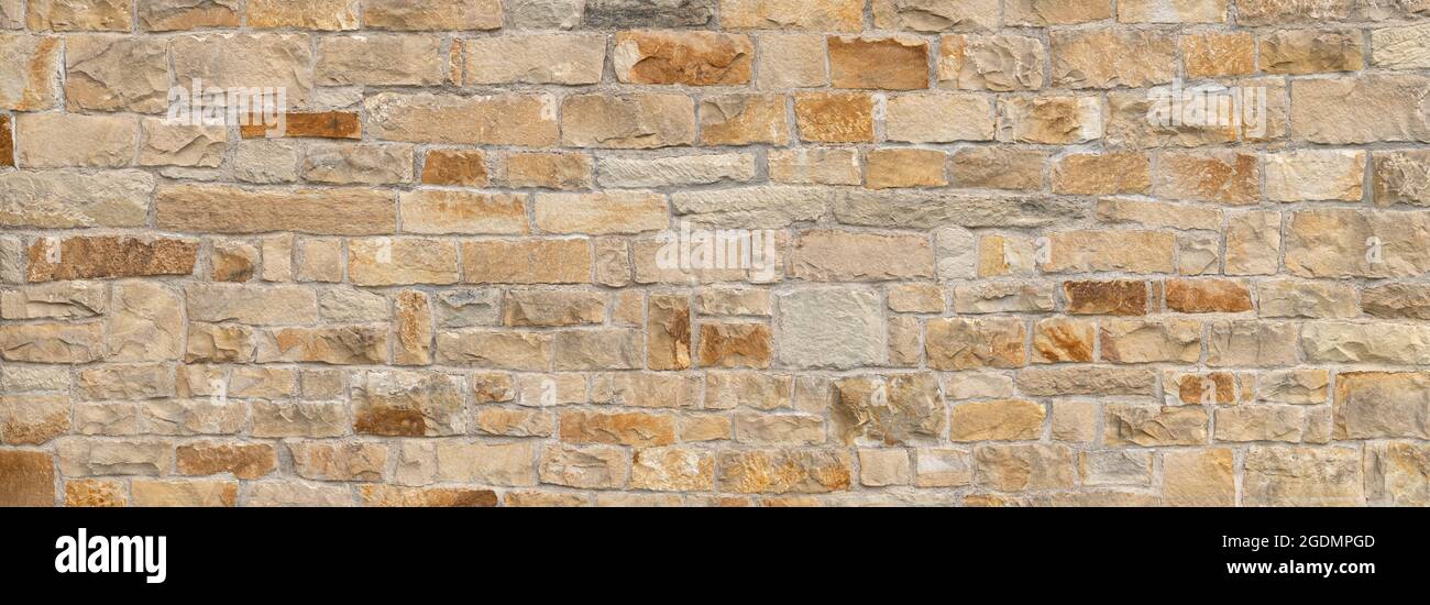 Old beige brown panoramic natural stone wall Stock Photo