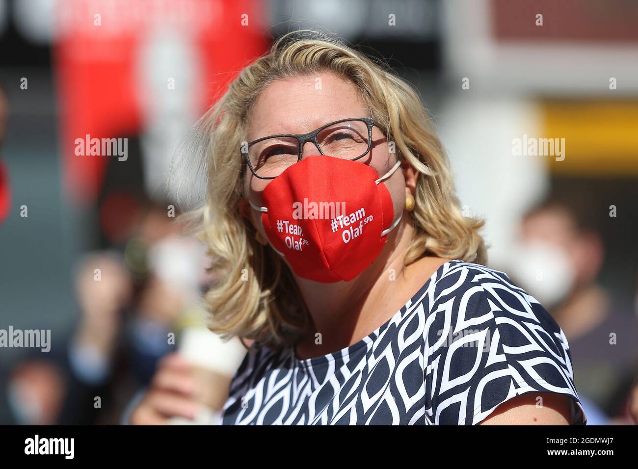 Bochum, Germany. 14th Aug, 2021. Svenja Schulze, (SPD) Federal Minister for the Environment, sits with a mouth guard with the inscription "Team Olaf SPD" on Dr. Rur Platz in Bochum. SPD candidate for chancellor Scholz starts the hot phase of the election campaign in the Ruhr area. Around six weeks before the federal election, he is speaking in the city centre of Bochum to kick off his tour. Credit: David Young/dpa/Alamy Live News Stock Photo