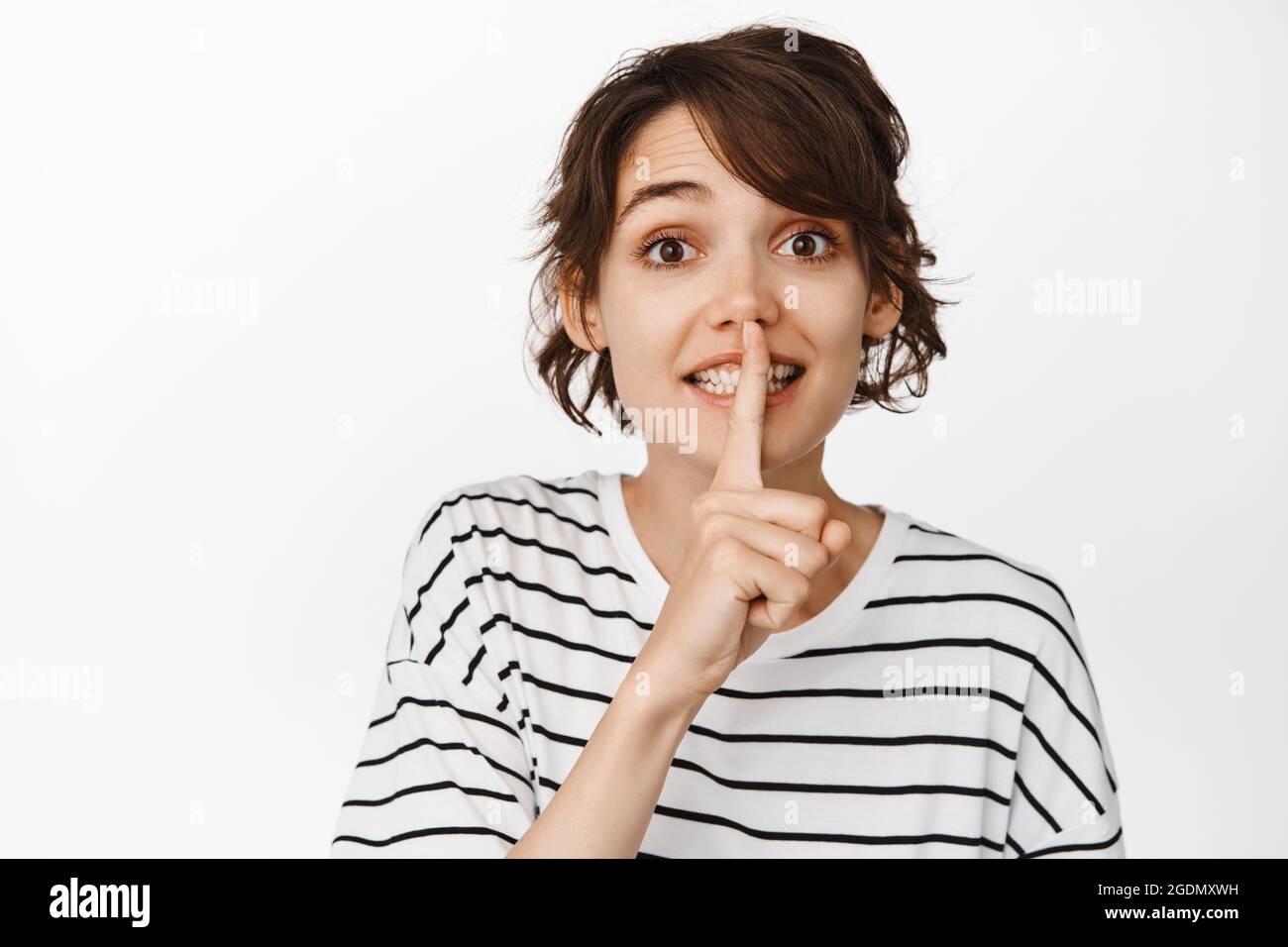 Image Of Cute Brunette Woman Hush Gesture Smiling And Talking Quiet Shushing Telling Secret