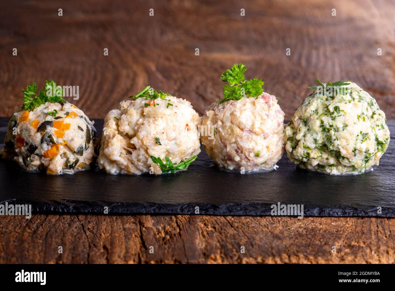 four different dumplings on slate Stock Photo