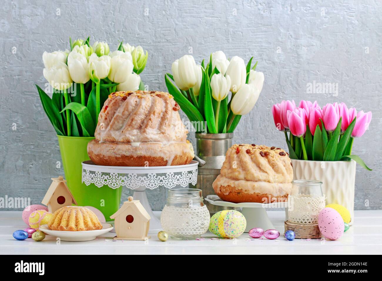 Easter table with cakes, eggs and flowers. Festive decor Stock Photo