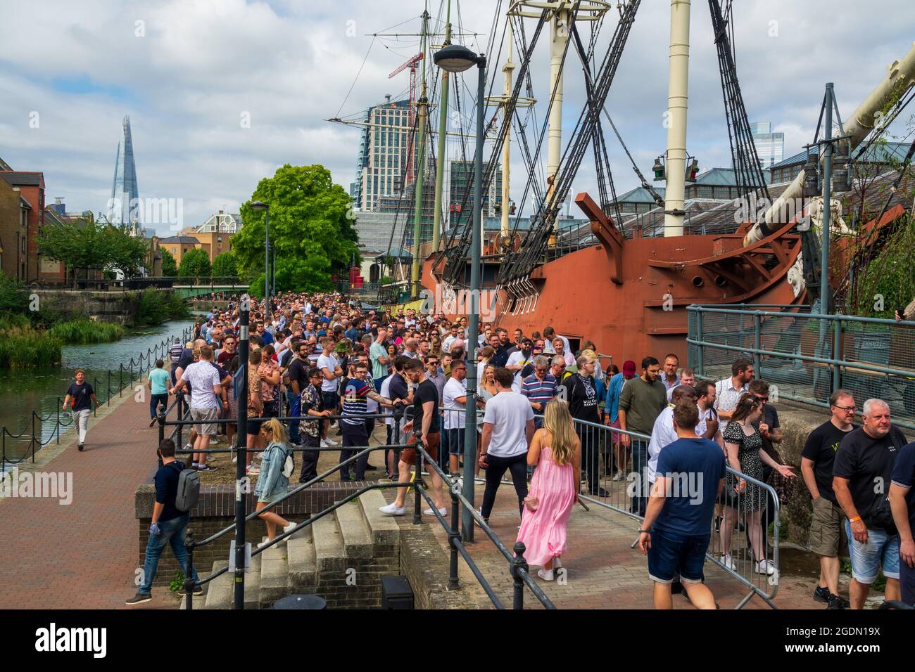 craft beer festival tobacco dock London, UK. 14th August 2021. Hundreds of people attend London Craft Beer  Festival at Tobacco Dock. Queues extended over a kilometre down and back up  the canal with some customers walking away