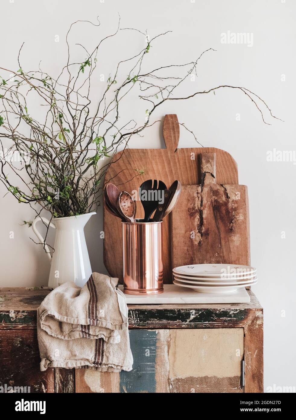 Kitchen utensils, chopping boards and plates on rustic counter Stock Photo