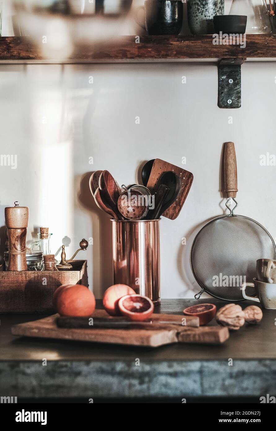 Kitchen utensils and chopped fruit on concrete kitchen counter Stock Photo