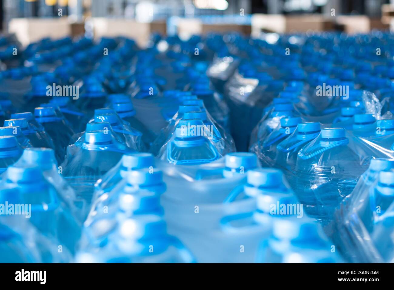 Blue fiveliter plastic water bottles packed at the warehouse of
