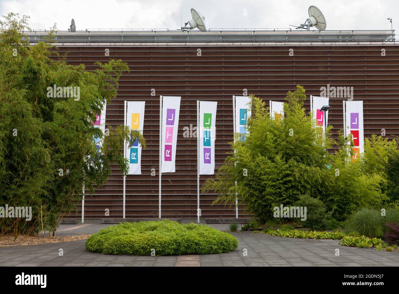 flags at the headquarters of the Media Group RTL Germany at Picassoplatz in Deutz, Cologne, Germany.  Fahnen am Hauptsitz der Mediengruppe RTL Deutsch Stock Photo