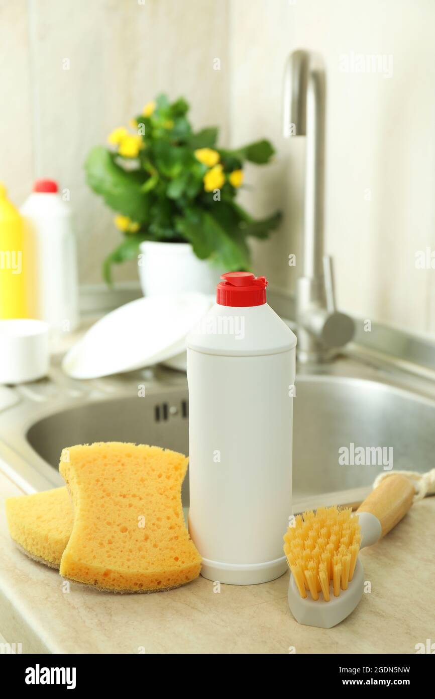 https://c8.alamy.com/comp/2GDN5NW/concept-of-dishwashing-detergent-accessories-on-kitchen-background-2GDN5NW.jpg