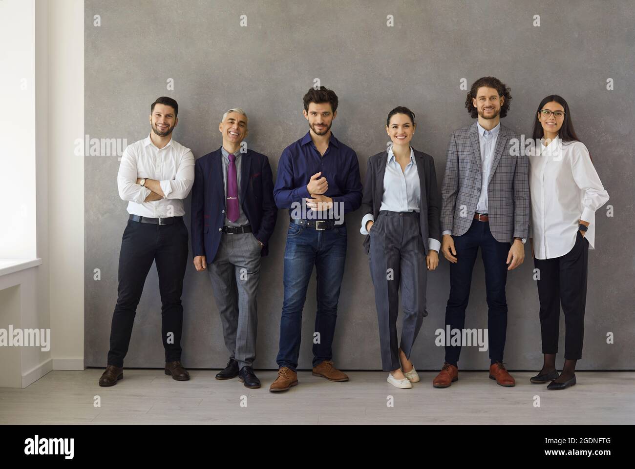 Group portrait of happy successful business professionals standing in office together Stock Photo