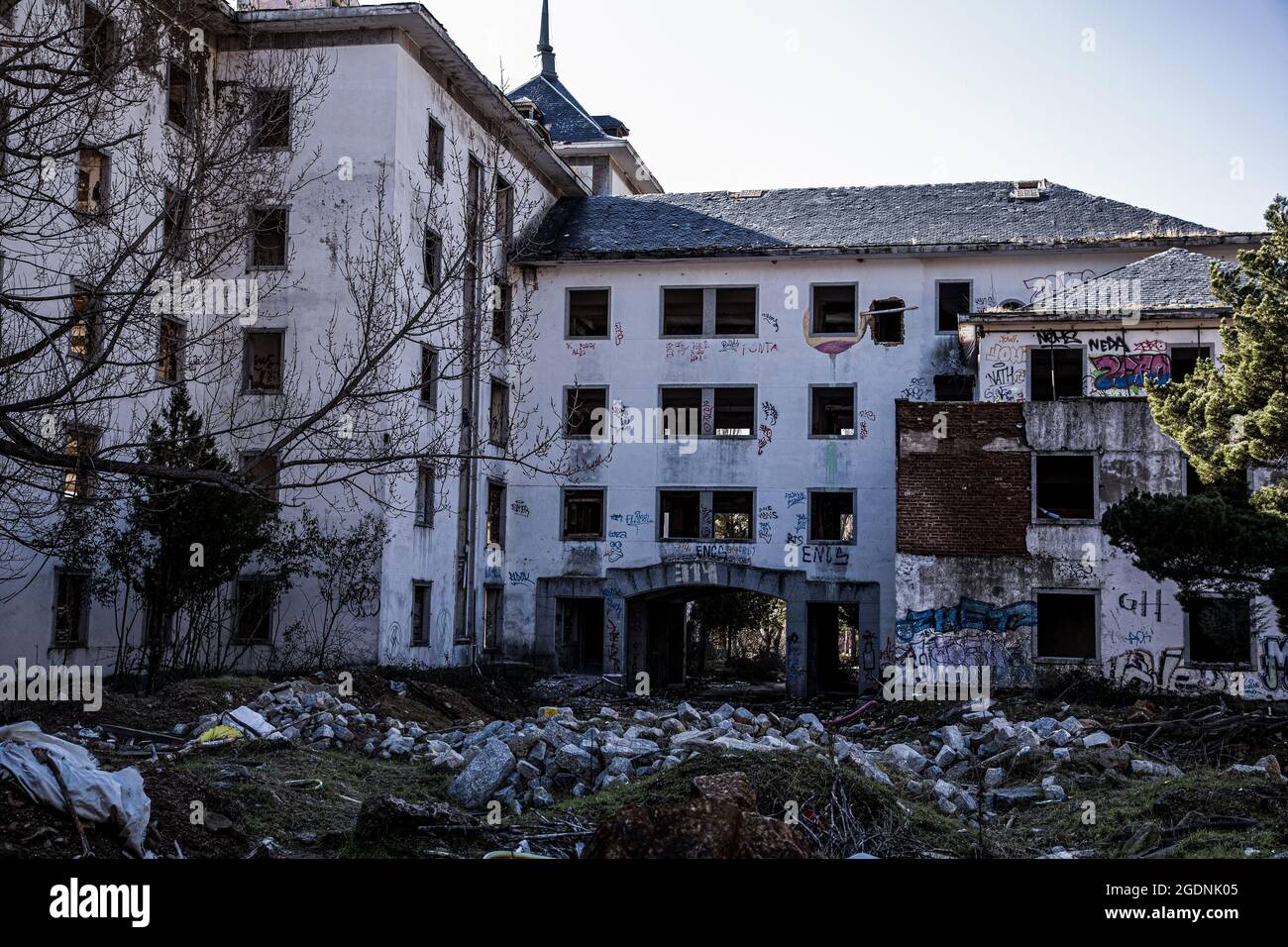 Interior and exterior of an old tuberculosis hospital located on a mountain  slope, made with granite stone, abandoned, looted, burned and very deterio  Stock Photo - Alamy, image size:1300x956