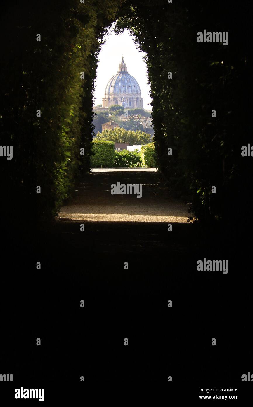 An amazing view of St. Peter's Dome through the Knights of Malta keyhole on the Aventine Hill in Rome. Stock Photo