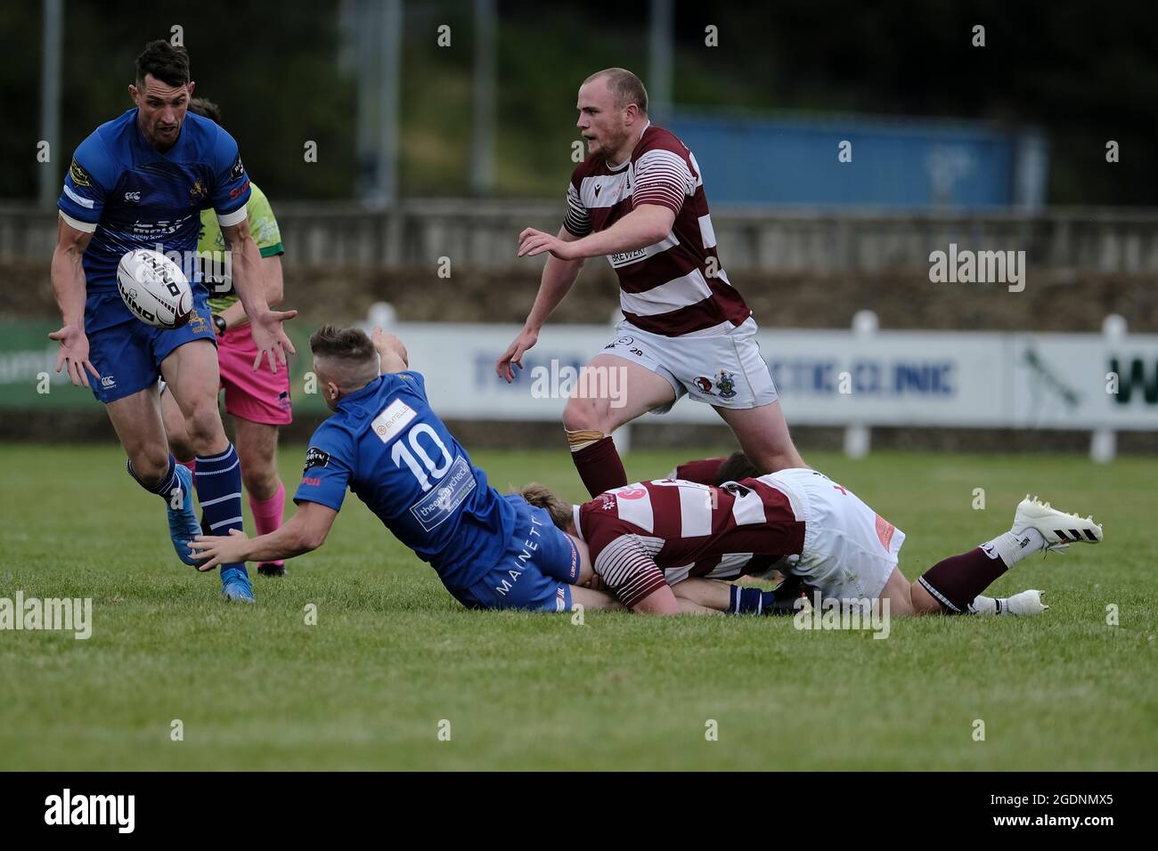 Hawick, UK. 14th Aug, 2021. Action from the Hawick 7s on Saturday 14 August 2021 at Mansfield, Hawick. Kieran Hayes (JedForest RFC) tackled to ground passing the ball to team mate Lewis Young (JedForest RFC) in the pool match against Watsonians. Credit: Rob Gray/Alamy Live News Stock Photo