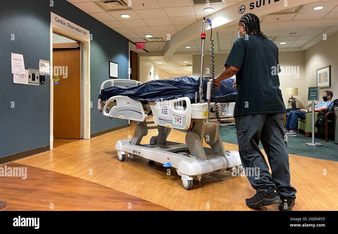 Atlanta, GA USA - March 26, 2021:  A Piedmont Hospital worker moving a bed to the Cardiac Care Observation unit in Atlanta, GA. Stock Photo