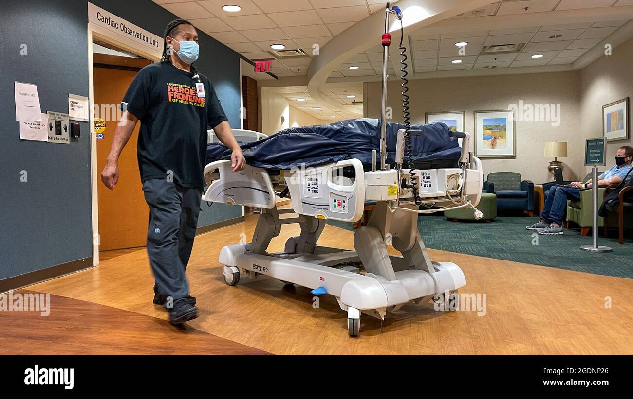 Atlanta, GA USA - March 26, 2021:  A Piedmont Hospital worker moving a bed to the Cardiac Care Observation unit in Atlanta, GA. Stock Photo