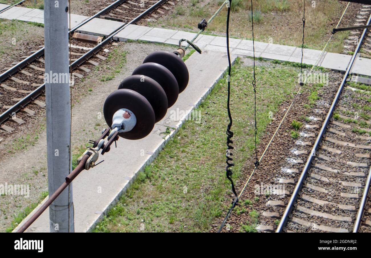 A railroad overhead power line component along a track with a rail